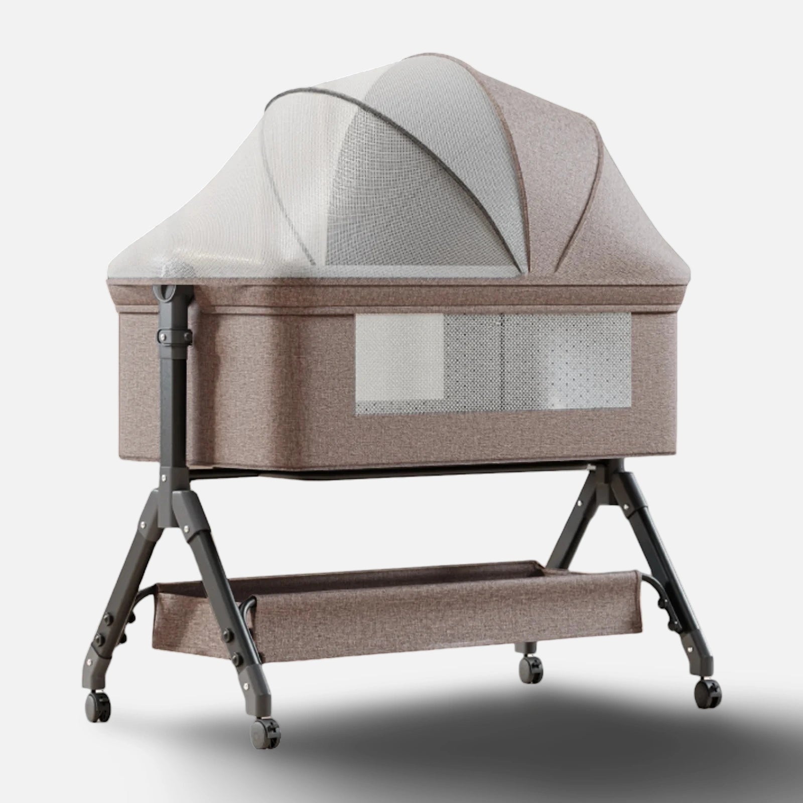 Grå bedside crib med integrerad skötbordsbädd och rymlig förvaringskorg undertill